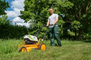 AS-Motor AS 510 E-ProClip A AP in action mowing grass, young man walking behind the mower