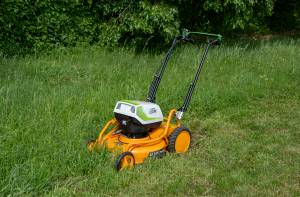 AS-Motor AS 510 E-ProClip A AP in action mowing grass, young man walking behind the mower