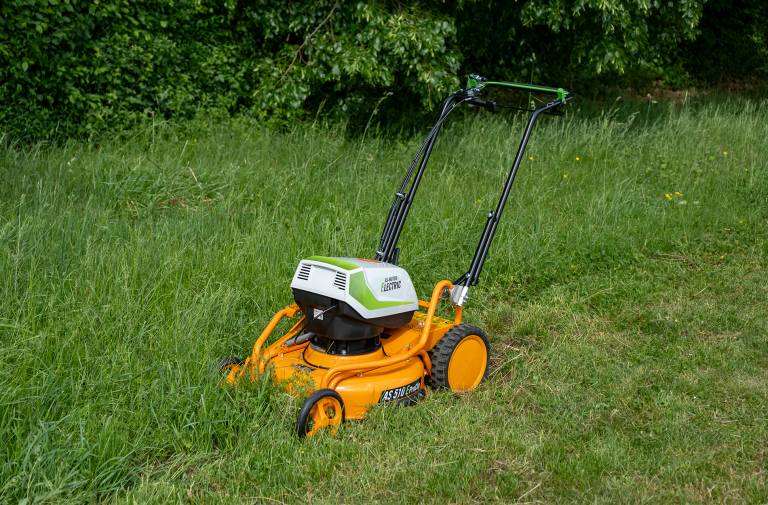 AS-Motor AS 510 E-ProClip A AP in action mowing grass, young man walking behind the mower
