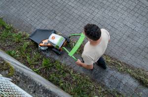 AS 30 E-WeedHex AP in action, brushing/removing weed on cobblestone