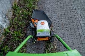 AS 30 E-WeedHex AP in action, brushing/removing weed on cobblestone
